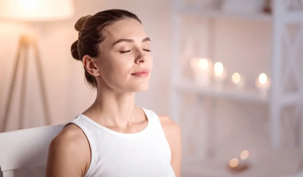 Woman sitting peacefully with eyes closed, representing hypnosis support for High-Functioning Anxiety relief and inner calm in daily life.
