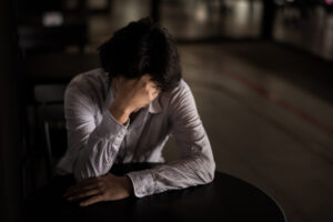 A woman stressed from work because of negative thinking patterns.