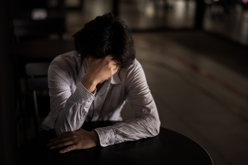 A woman stressed from work because of negative thinking patterns.