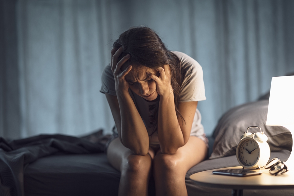 Woman having a headache because of rumination anxiety.