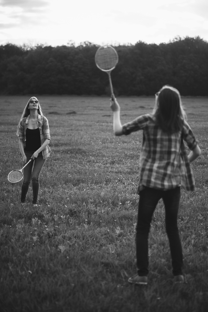 Two women playing badminton because of anxious attachment.