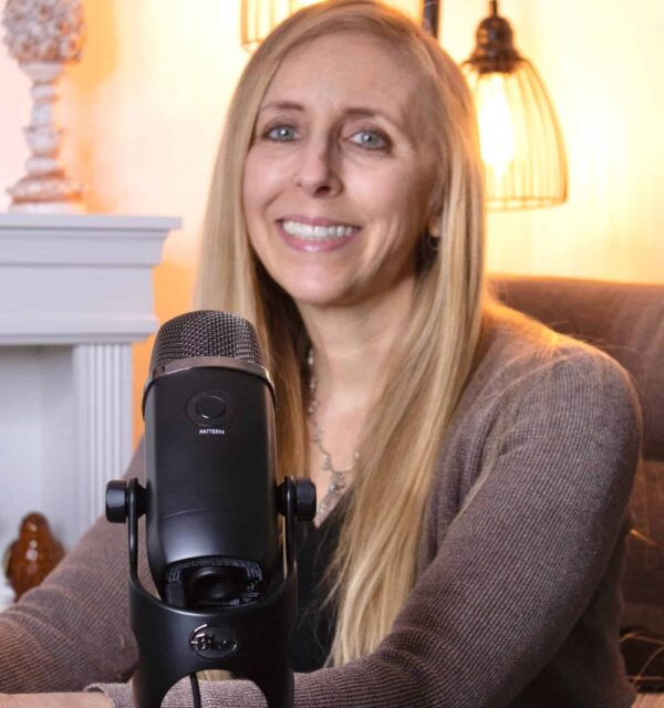 Tiffani Cappello speaking into a microphone during a podcast or guided hypnosis recording session